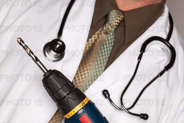 Doctor with stethoscope holding A very big drill