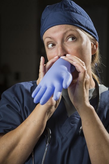 Playful funny doctor or nurse inflating surgical glove