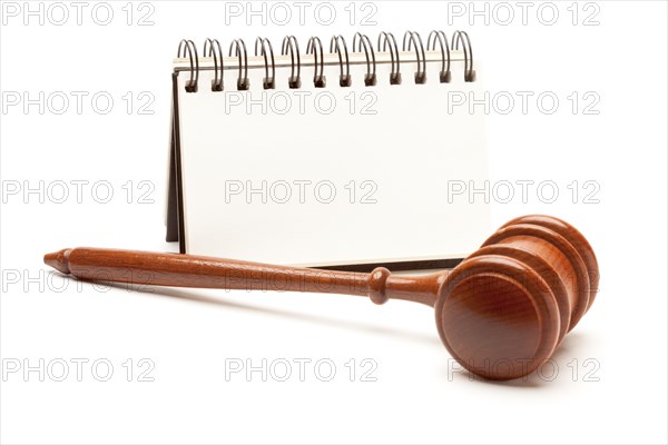 Blank spiral note pad and gavel isolated on white