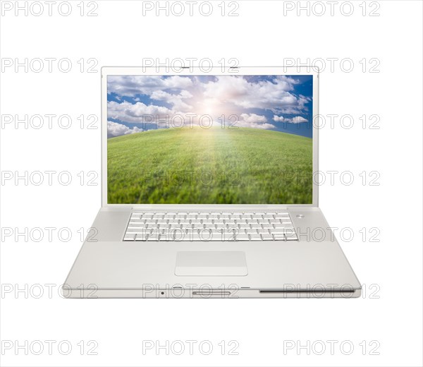 Silver computer laptop with arched horizon of grass field and sky isolated on a white background
