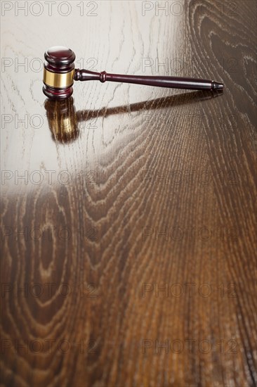 Dark wooden gavel abstract on reflective table with room for text