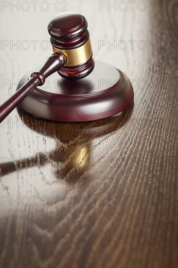 Dark wooden gavel abstract on reflective table with room for text