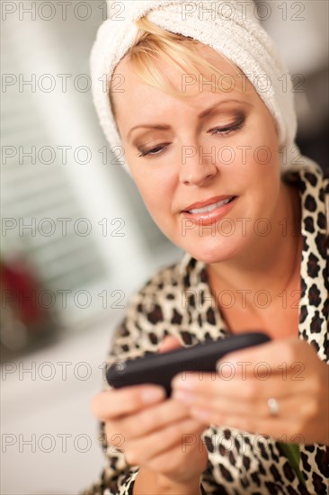 Attractive woman texting with her cell phone with narrow depth of field
