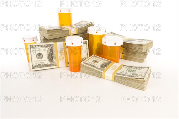 Empty medicine bottles and stacks of hundreds of dollars on reflective surface