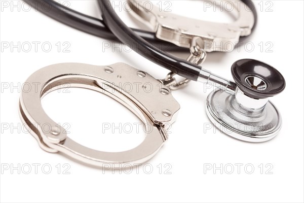 Stethoscope and handcuffs isolated on a white background