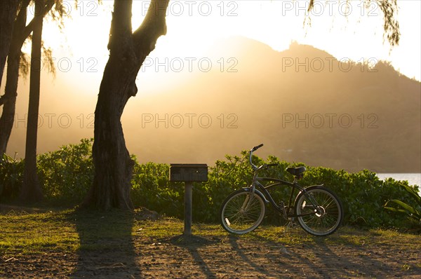 Sunset on hanalei bay with backlit bike and BBQ