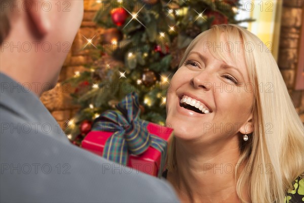 Attractive girl exchanging A gift at A christmas party