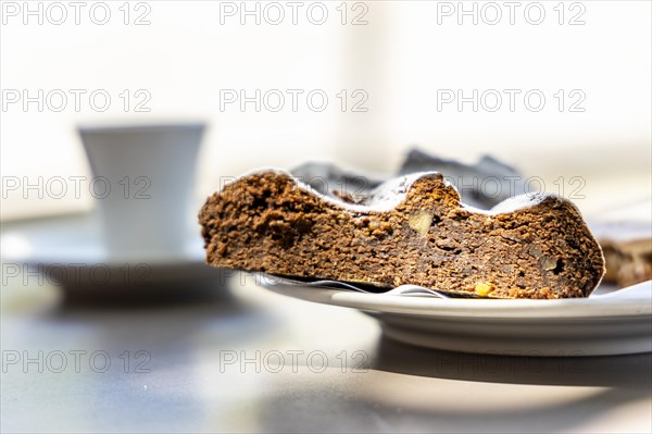 Portuguese dessert made of cornflour and honey called broa de mel with coffee in the background