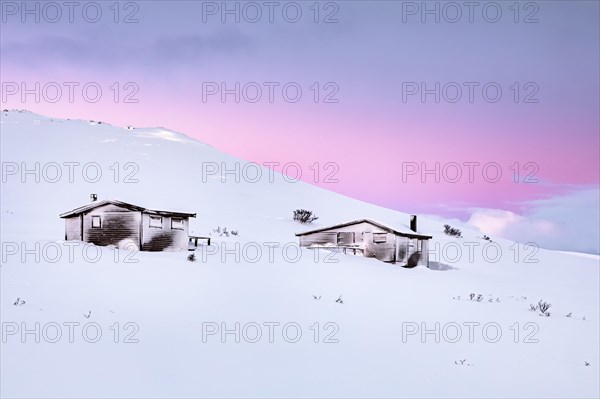 Cabins in winter landscape