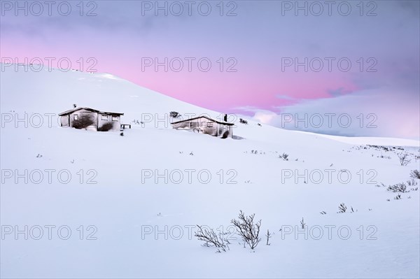 Cabins in winter landscape