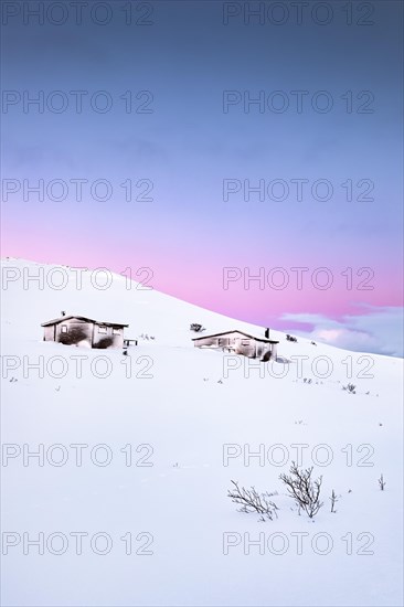 Cabins in winter landscape