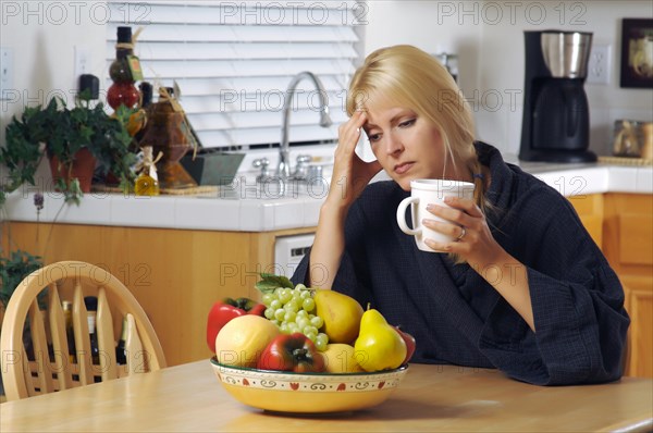 Woman with hand on her head as she gazes in thought. head ache? depression? loneliness? versatile image