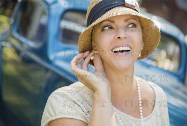 Beautiful 1920s dressed girl near vintage car outdoors portrait