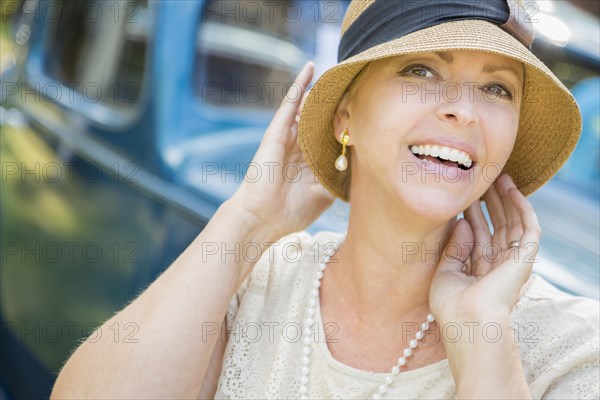 Beautiful 1920s dressed girl near vintage car outdoors portrait