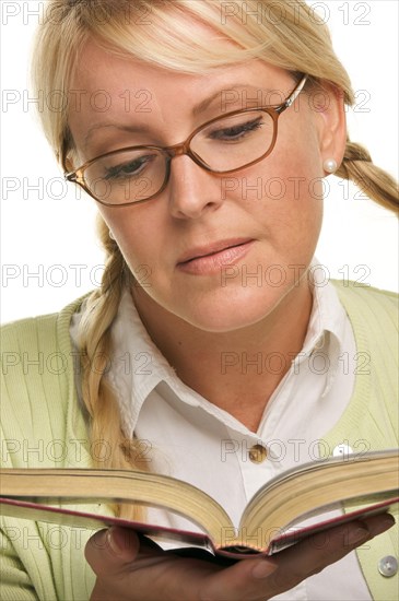 Female with ponytails reads her book isolated on a white background