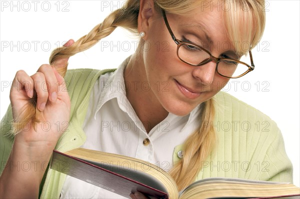 Female with ponytails reads her book isolated on a white background