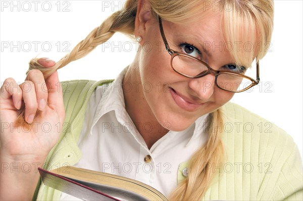 Female with ponytails reads her book isolated on a white background