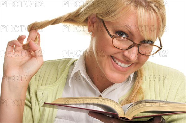 Female with ponytails reads her book isolated on a white background