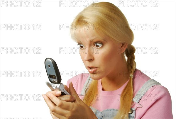 Enamored girl texting with cell phone on a white background