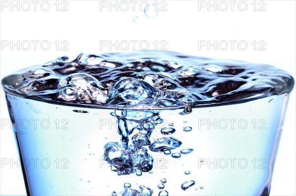 Glass filled with bubbling water