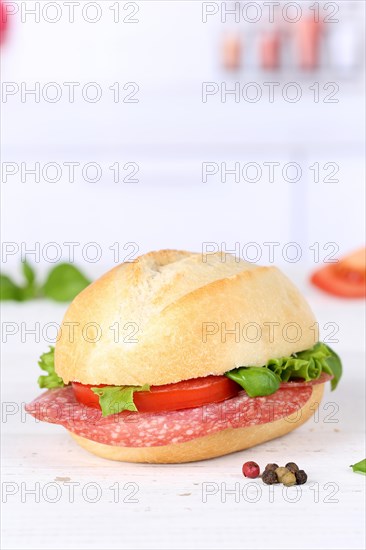 Roll sandwich baguette topped with salami ham text free space copyspace on wooden board in germany