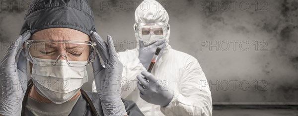Female and male doctors or nurses wearing scrubs and protective mask and goggles banner