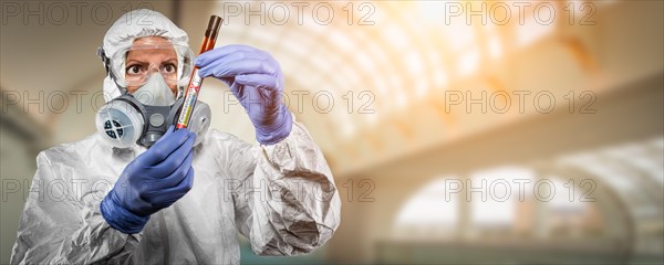 Female doctor or nurse in hazmat gear holding positive coronavirus test tube banner