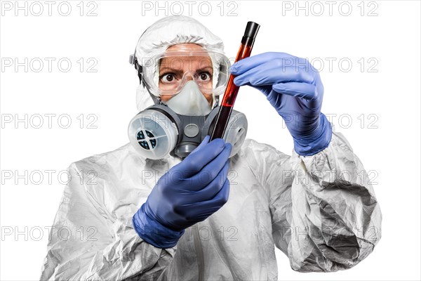 Woman in hazmat suit and gas mask holding test tube of blood isolated on white background