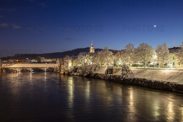 View of river Aare with wooden bridge in winter