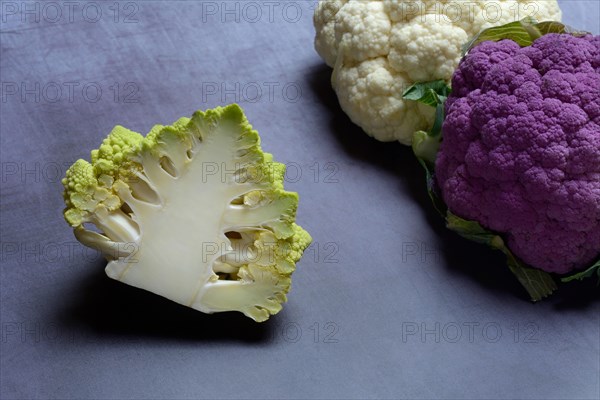 Halved cauliflower Romanesco and purple and white cauliflower