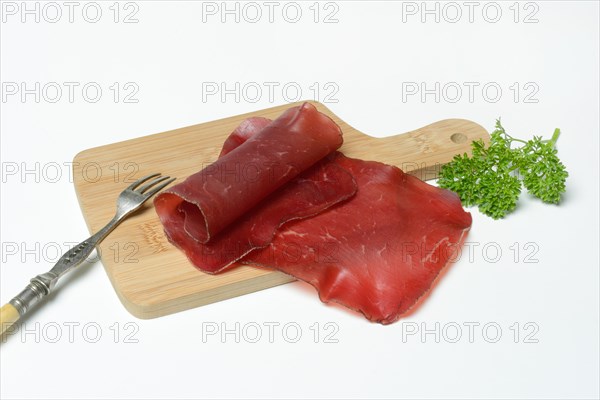 Buendner dried meat on wooden board with fork