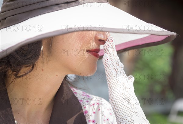Pretty 1920s era dressed girl with classic hat and gloves