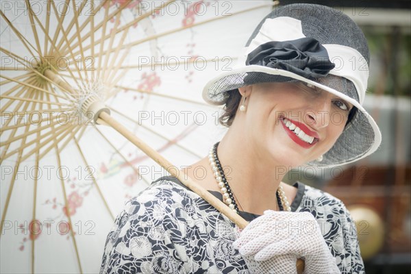 Beautiful 1920s dressed girl with parasol portrait