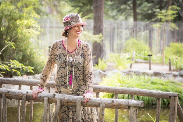 Attractive 1920s dressed girl on wooden bridge portrait