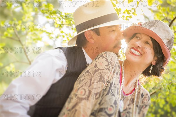 Attractive 1920s dressed romantic couple flirting outdoors