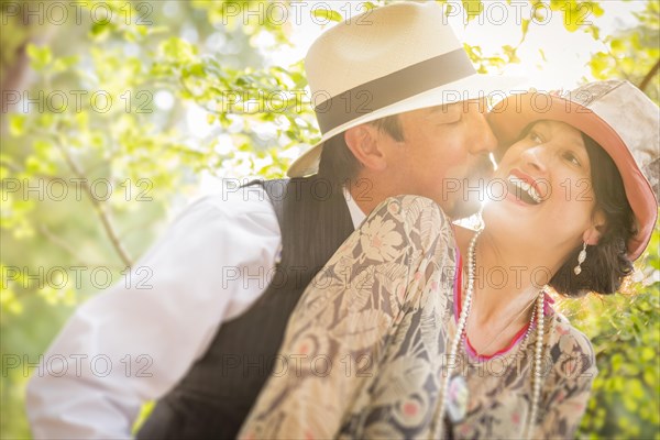 Attractive 1920s dressed romantic couple flirting outdoors