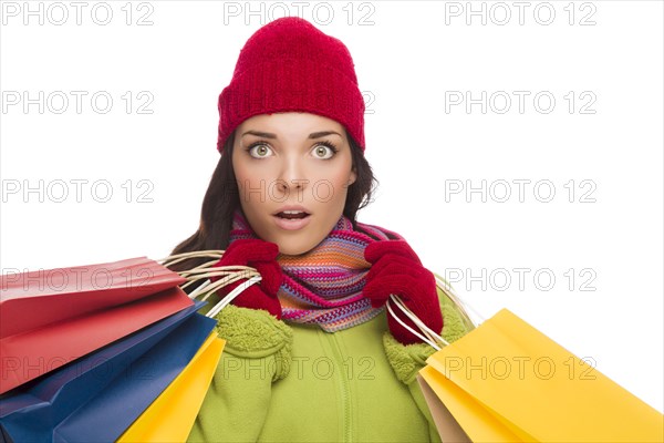 Beautiful mixed-race woman wearing winter hat and gloves isolated on a white background