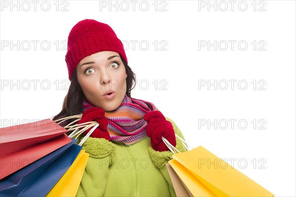 Beautiful mixed-race woman wearing winter hat and gloves isolated on a white background