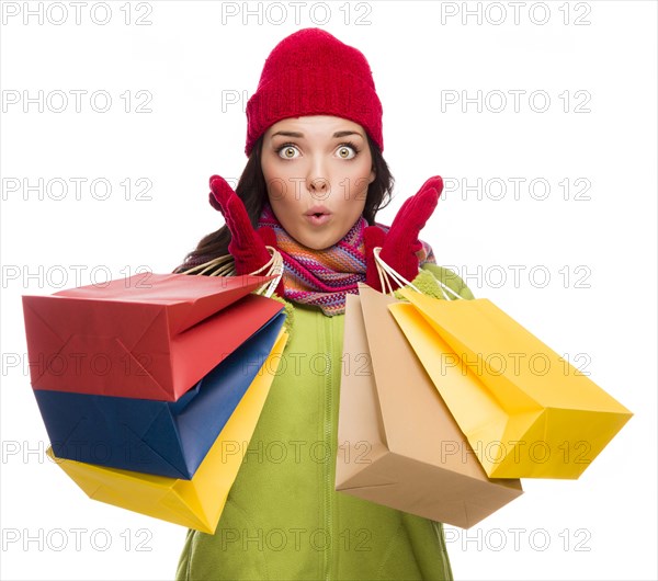 Beautiful mixed-race woman wearing winter hat and gloves isolated on a white background