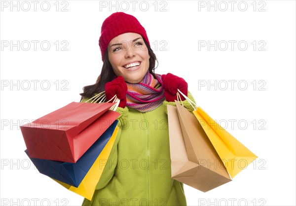 Beautiful mixed-race woman wearing winter hat and gloves isolated on a white background looking to the side