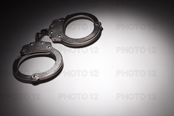 Abstract pair of handcuffs under spot light with room for your own text