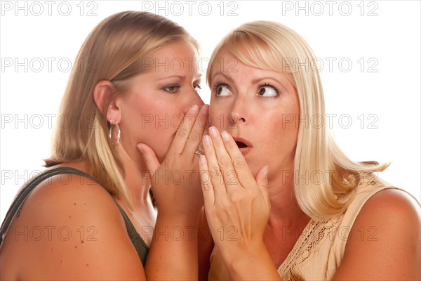 Two blonde woman whispering secrets isolated on a white background