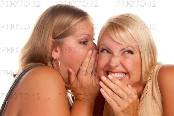 Two blonde woman whispering secrets isolated on a white background