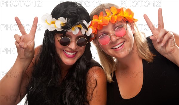 Two beautiful hippie girls with peace signs isolated on a white background