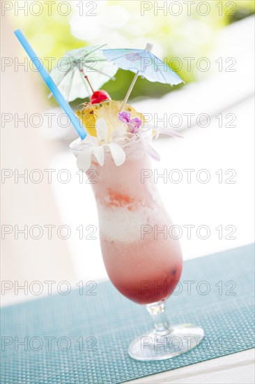 Fruity tropical drink with pineapple and umbrellas at the bar