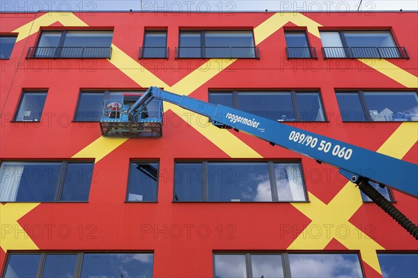 Colorful facade with window cleaners