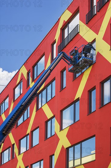 Colorful facade with window cleaners