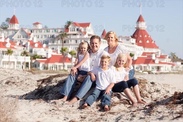 Happy caucasian family in front of hotel del coronado on a sunny afternoon