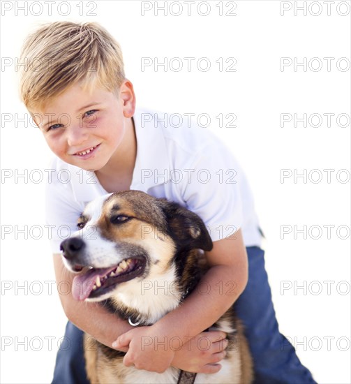 Handsome young boy playing with his dog isolated on a white background