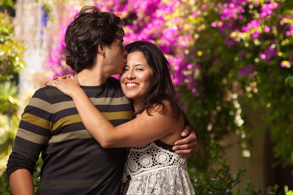 Happy attractive hispanic couple enjoying themselves at the park